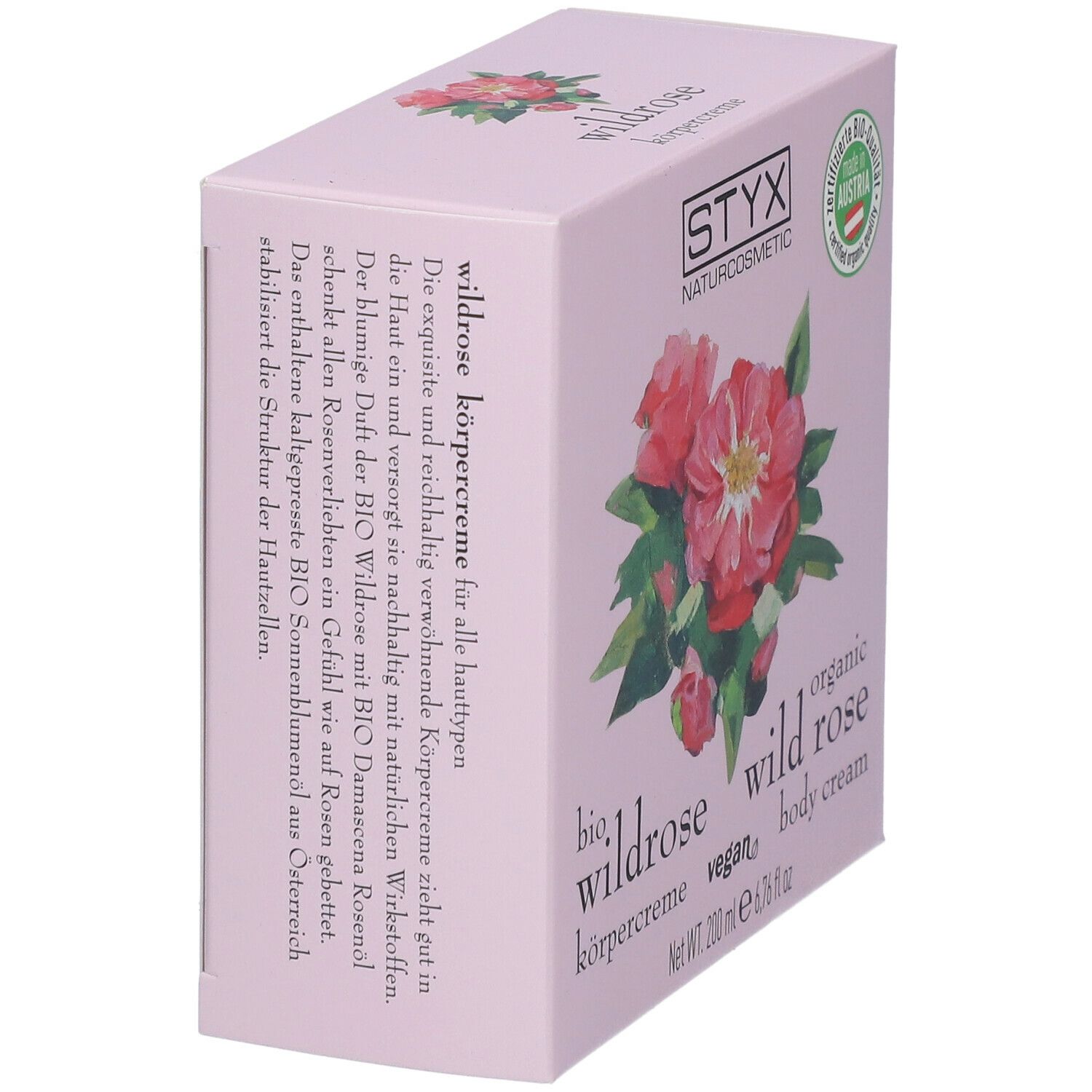 Confezione rosa inclinata. Logo STYX, illustrazione di rosa selvatica, testo: crema corpo alla rosa selvatica.