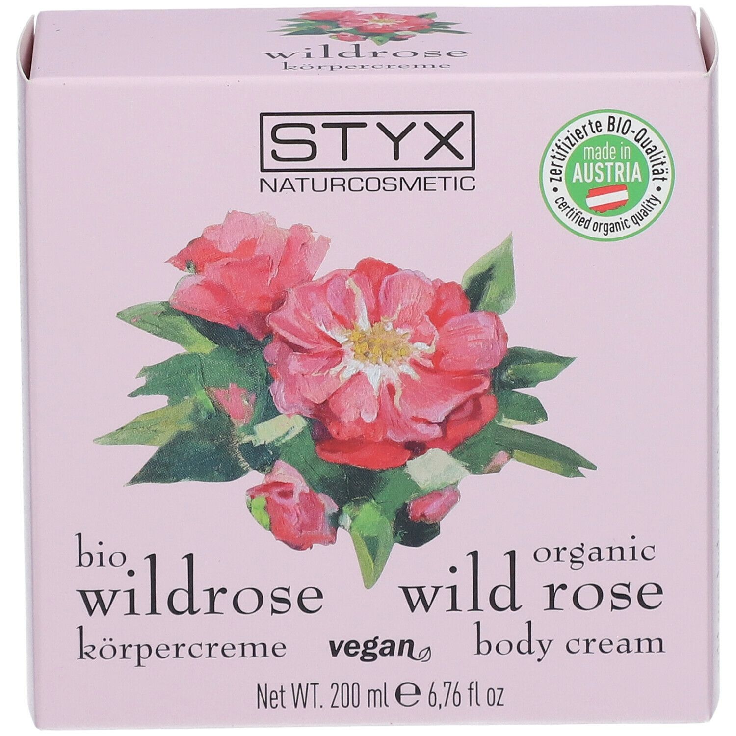 Confezione rosa con logo STYX, illustrazione di rosa selvatica, testo: crema corpo alla rosa selvatica, 200 ml.
