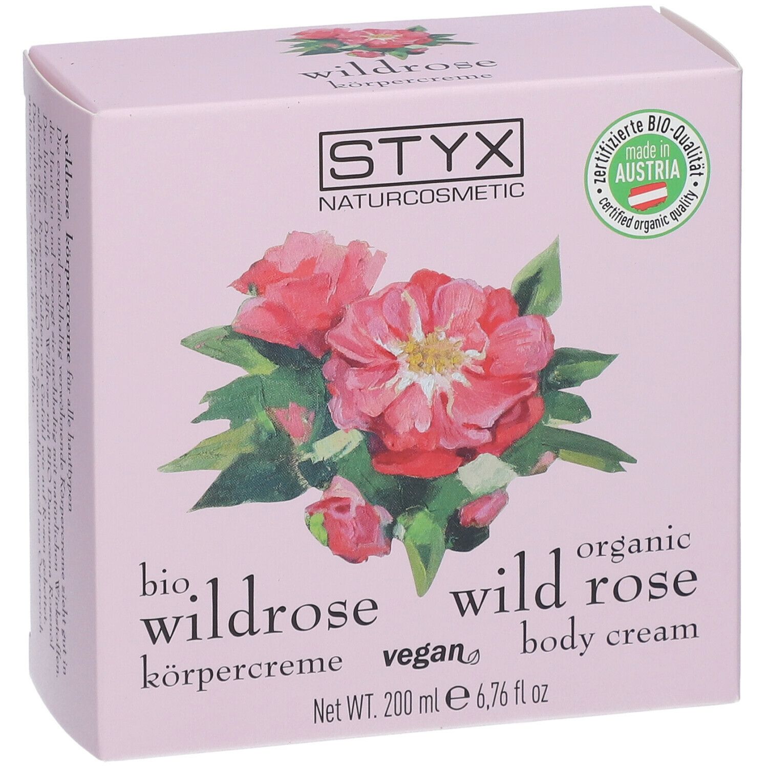 Confezione rosa con logo STYX, illustrazione di rosa selvatica, testo: crema corpo alla rosa selvatica, 200 ml.