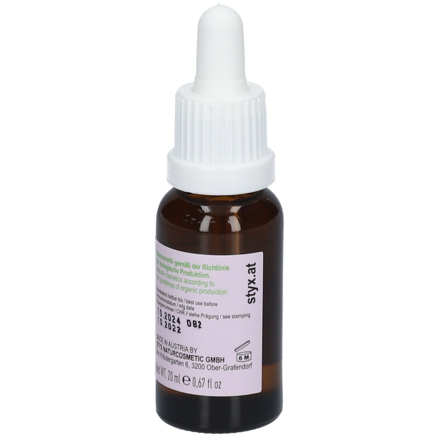 Flacone di vetro marrone con contagocce bianco. Etichetta con testo e numero di lotto. Scritto: Made in Austria.