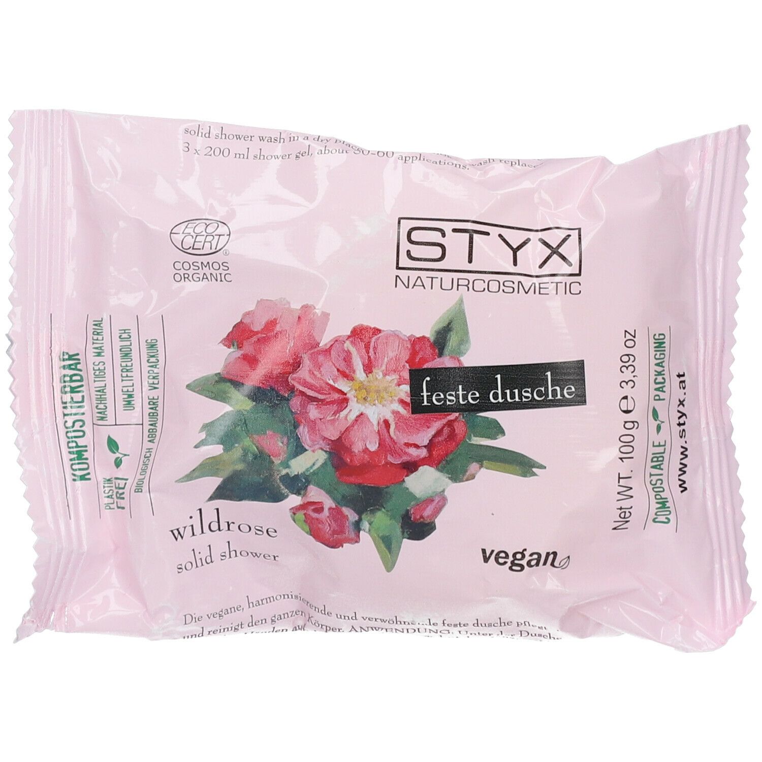 Detersivo solido rosa con illustrazione di rosa selvatica, logo STYX, certificazione Cosmos Organic ed etichetta vegana.