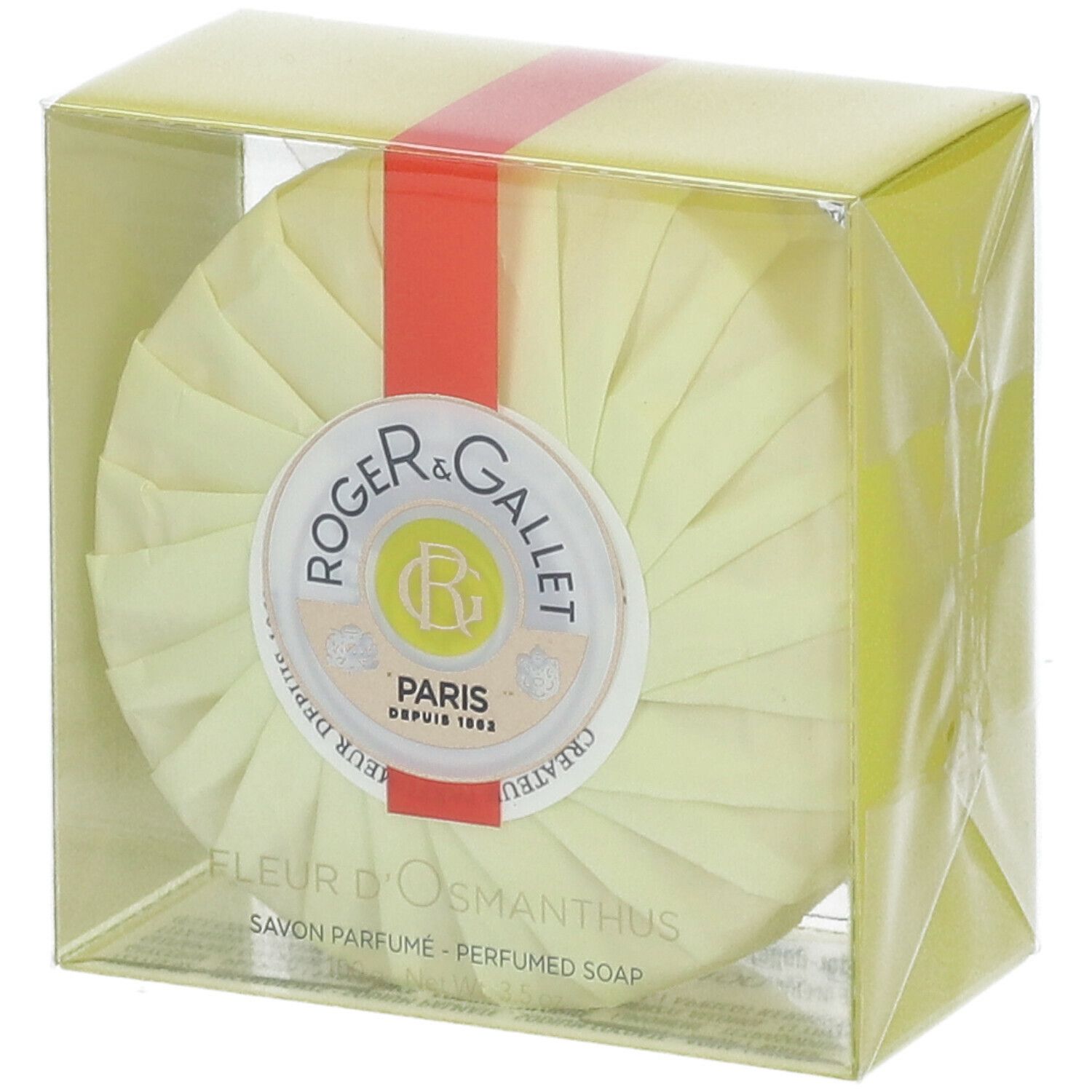 Sapone rotondo in confezione gialla. Nastro rosso. Logo Roger & Gallet. Testo: Fleur d'Osmanthus, Savon Parfume.