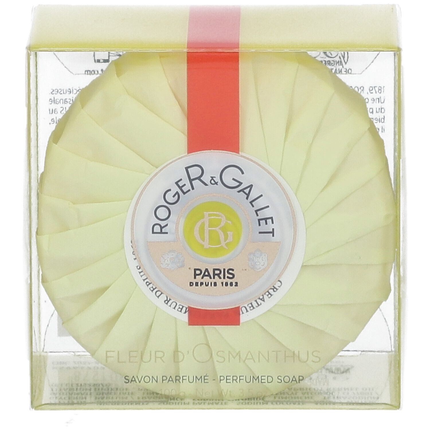 Sapone rotondo in confezione gialla. Nastro rosso. Logo Roger & Gallet. Testo: Fleur d'Osmanthus, Savon Parfume.
