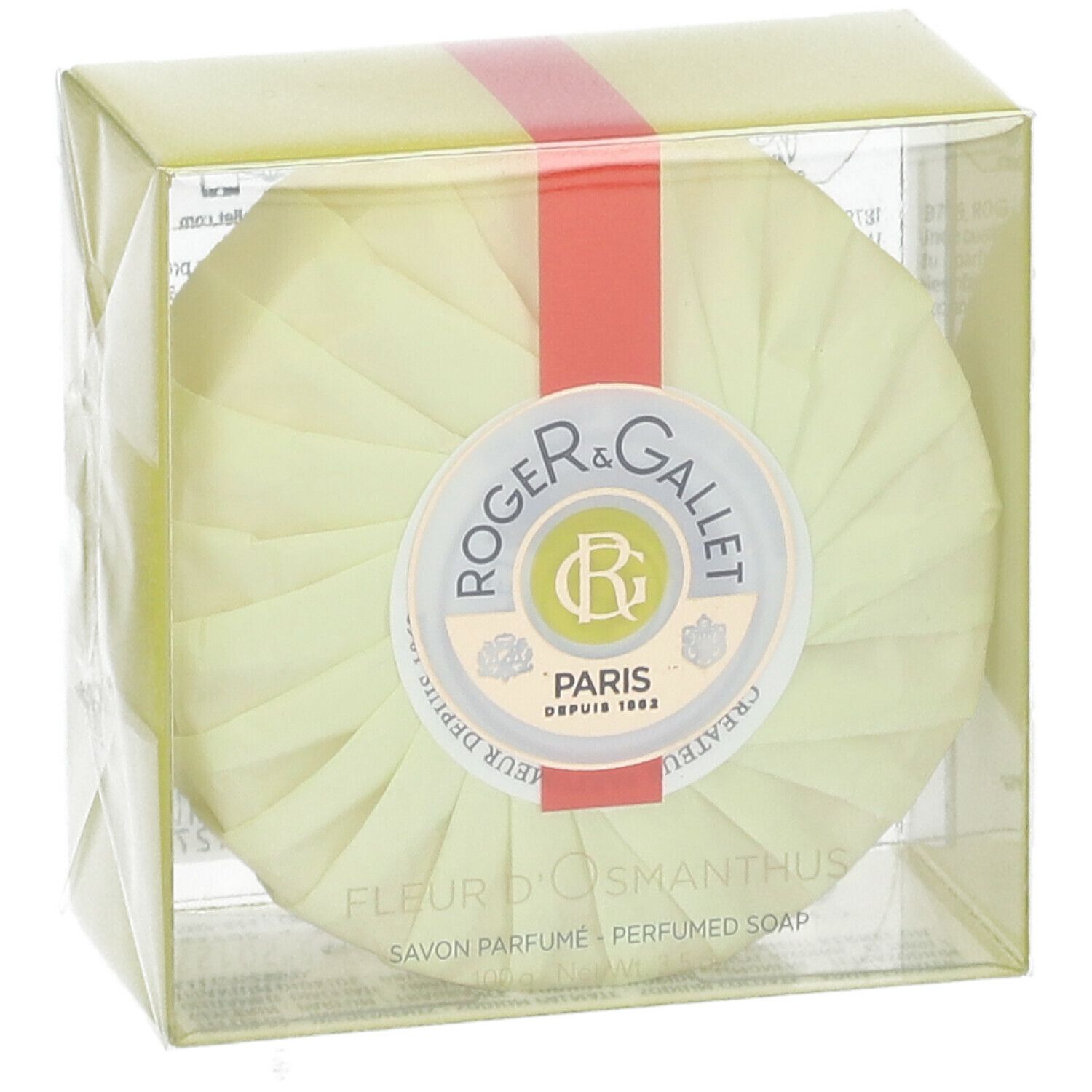 Sapone rotondo in confezione gialla. Nastro rosso. Logo Roger & Gallet. Testo: Fleur d'Osmanthus, Savon Parfume.
