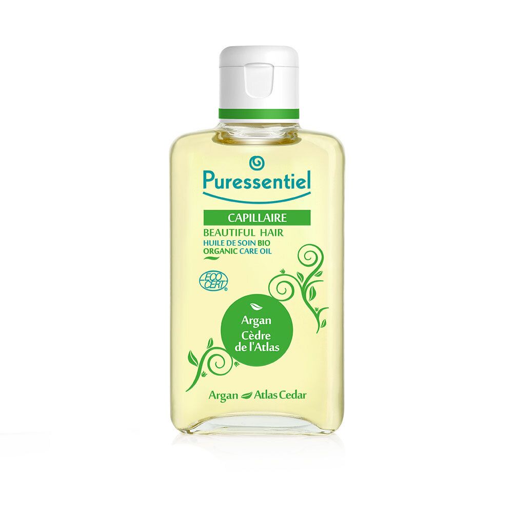 Flacone di olio per capelli. Scritta: Capillaire, Huile de soin bio, Argan Cèdre de l'Atlas. Con 7 oli essenziali.