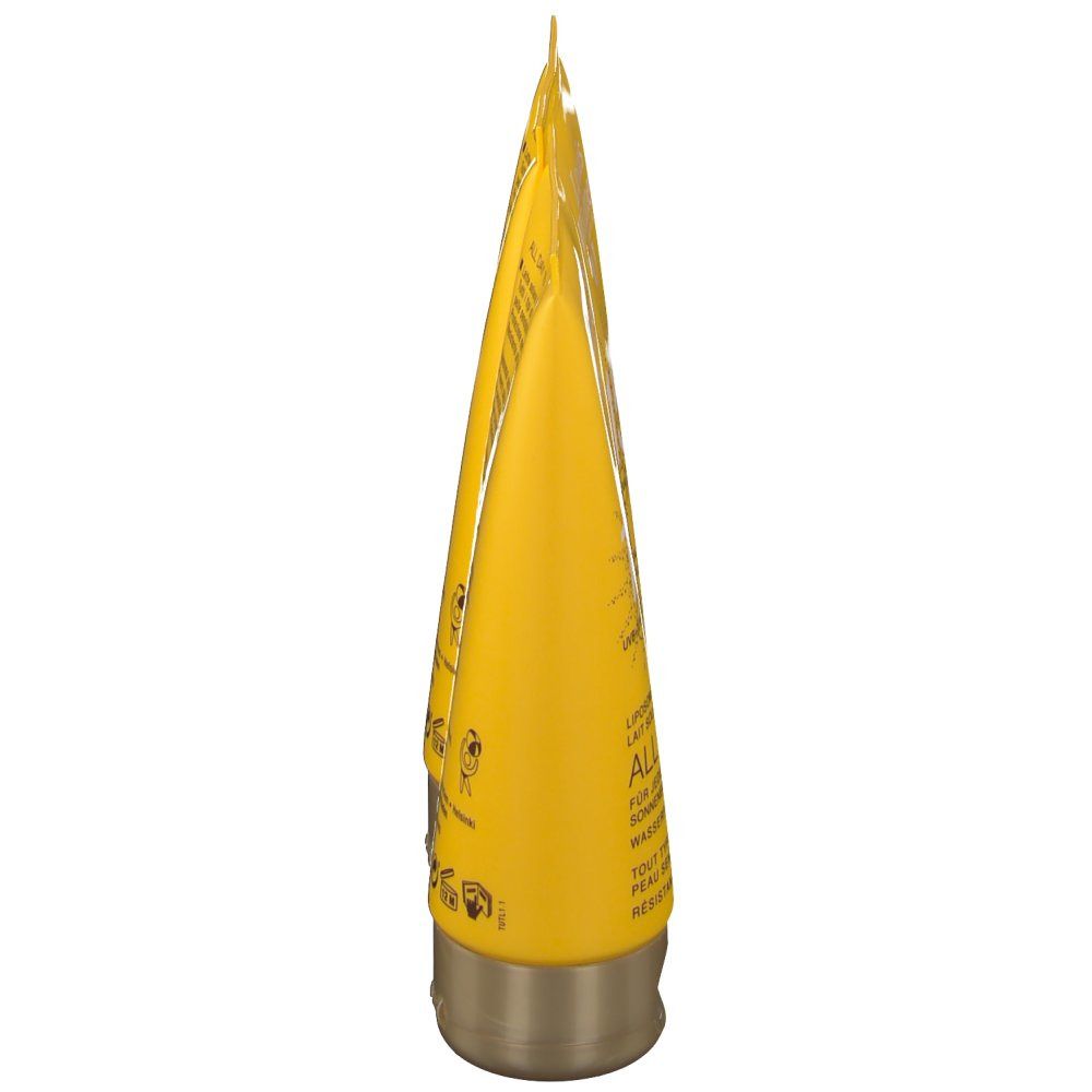 Tubo giallo, tappo dorato. Testo sul tubo.