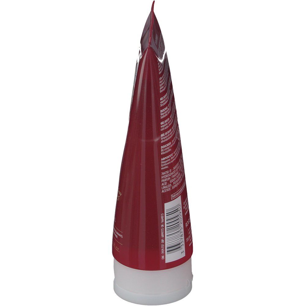 Vista laterale del tubo. Tubo rosso trasparente con tappo bianco. Testo sul retro.