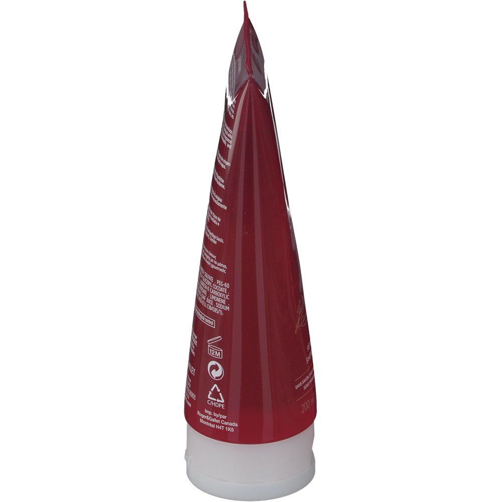 Vista laterale del tubo. Tubo rosso trasparente con tappo bianco. Testo sul retro.