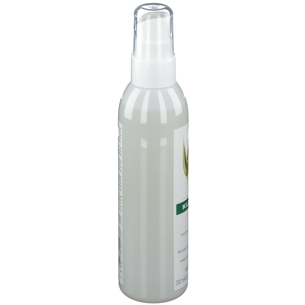 Flacone spray bianco, vista laterale. Etichetta verde con testo. Scritta: KLORANE.