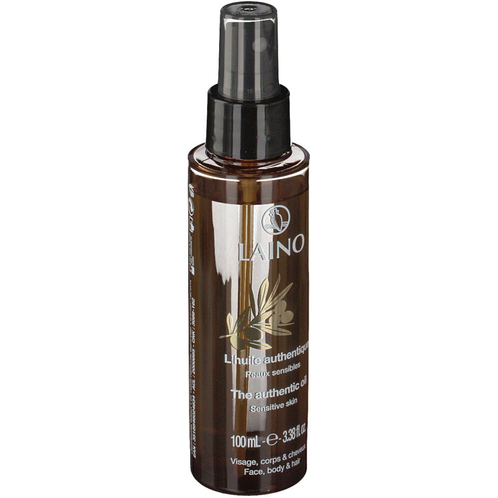 Flacone spray marrone con erogatore nero. Scritta: LAINO, L'huile authentique, The authentic oil, Pelle sensibile.