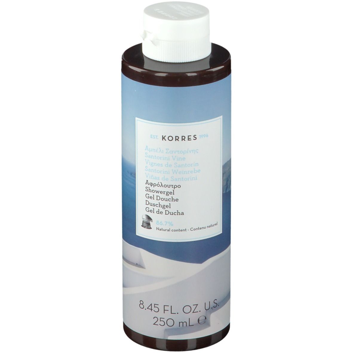 Gel doccia KORRES Santorini. Flacone cilindrico con tappo bianco. Etichetta con nome e informazioni.
