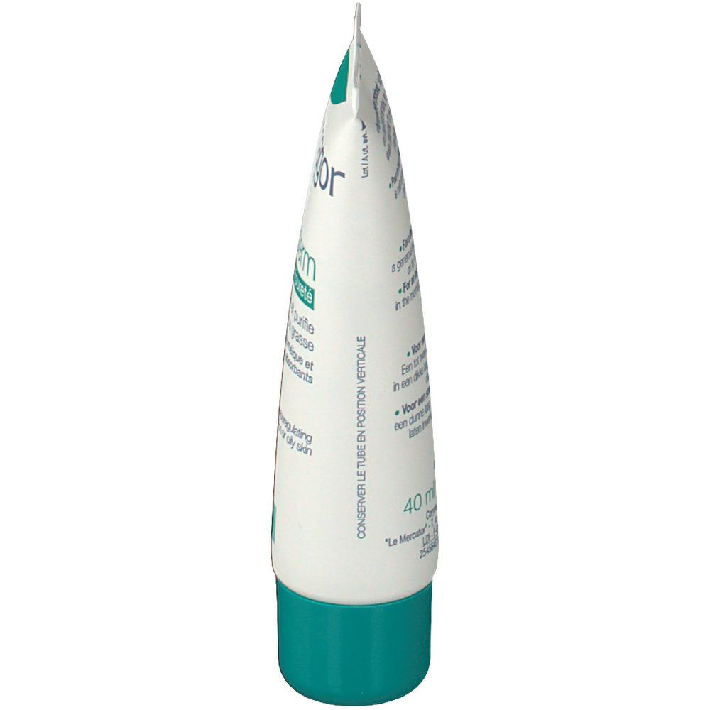 Vista laterale del tubo di crema. Confezione bianca e verde. Testo in francese e inglese.