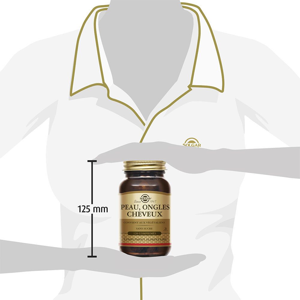 Persona che tiene in mano un flacone. Flacone con etichetta « Peau, Ongles, Cheveux ». Misura di 125 mm.