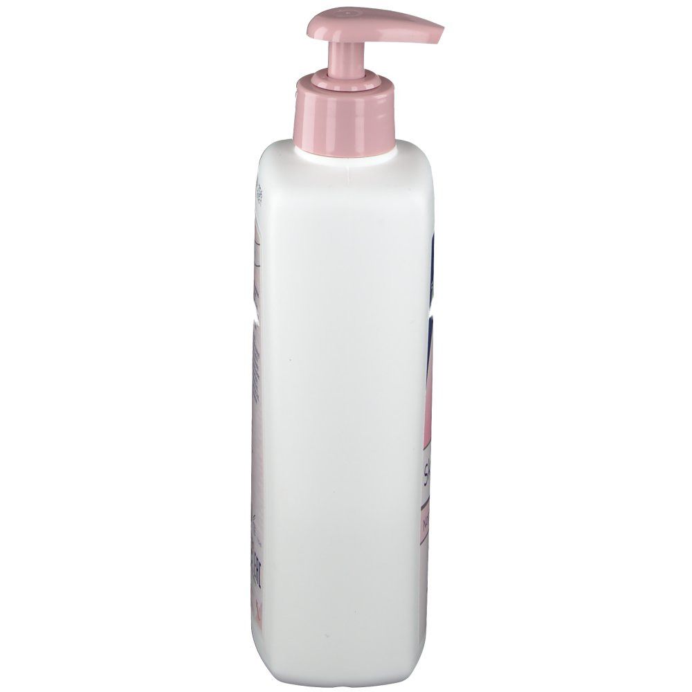 Flacone bianco con erogatore rosa. Vista laterale. Stampe sul flacone. Prodotto per la cura della pelle.