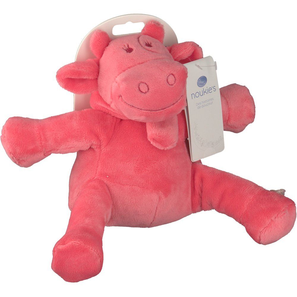 Peluche rosa a forma di mucca. Con etichetta. Materiale morbido. Braccia e gambe aperte. L'etichetta dice 'noukies'.
