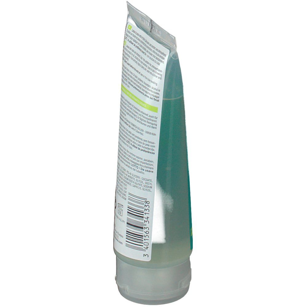 Vista laterale del retro di un tubo con gel verde. Testo multilingue. Codice a barre visibile.