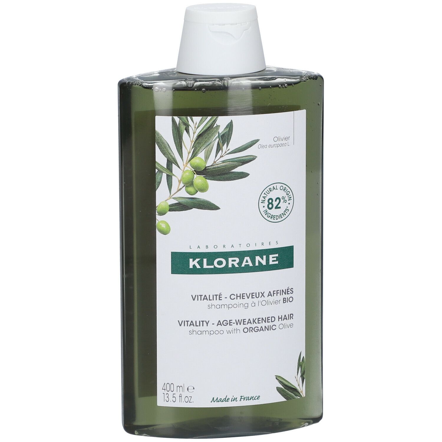 Flacone di shampoo verde con tappo bianco. Etichetta con illustrazione di olive e testo: KLORANE, Vitalité, 82% ingredienti di origine naturale.