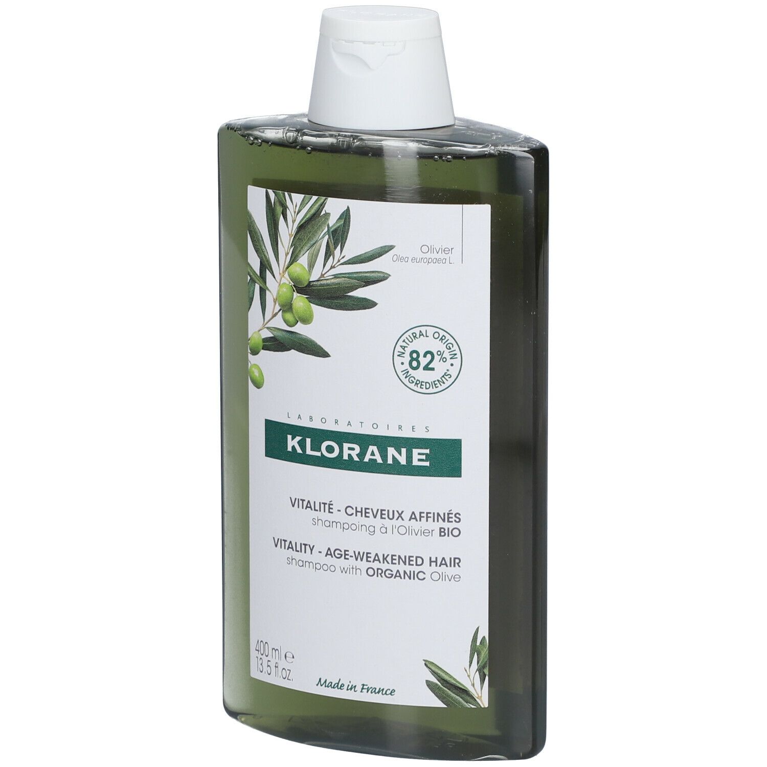 Flacone di shampoo verde con tappo bianco. Etichetta con illustrazione di olive e testo: KLORANE, Vitalité, 82% ingredienti di origine naturale.