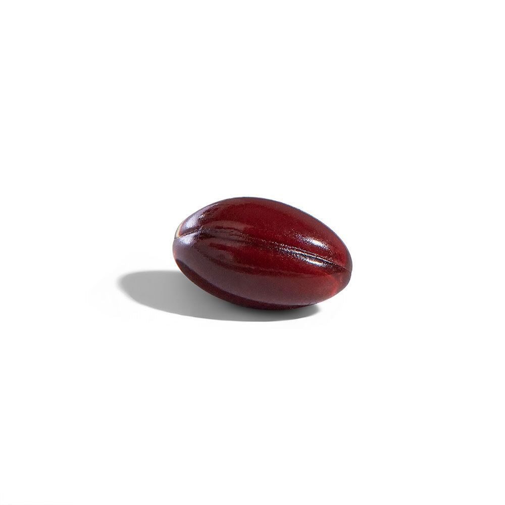 Singola capsula softgel, oblunga, rosso scuro su sfondo bianco.