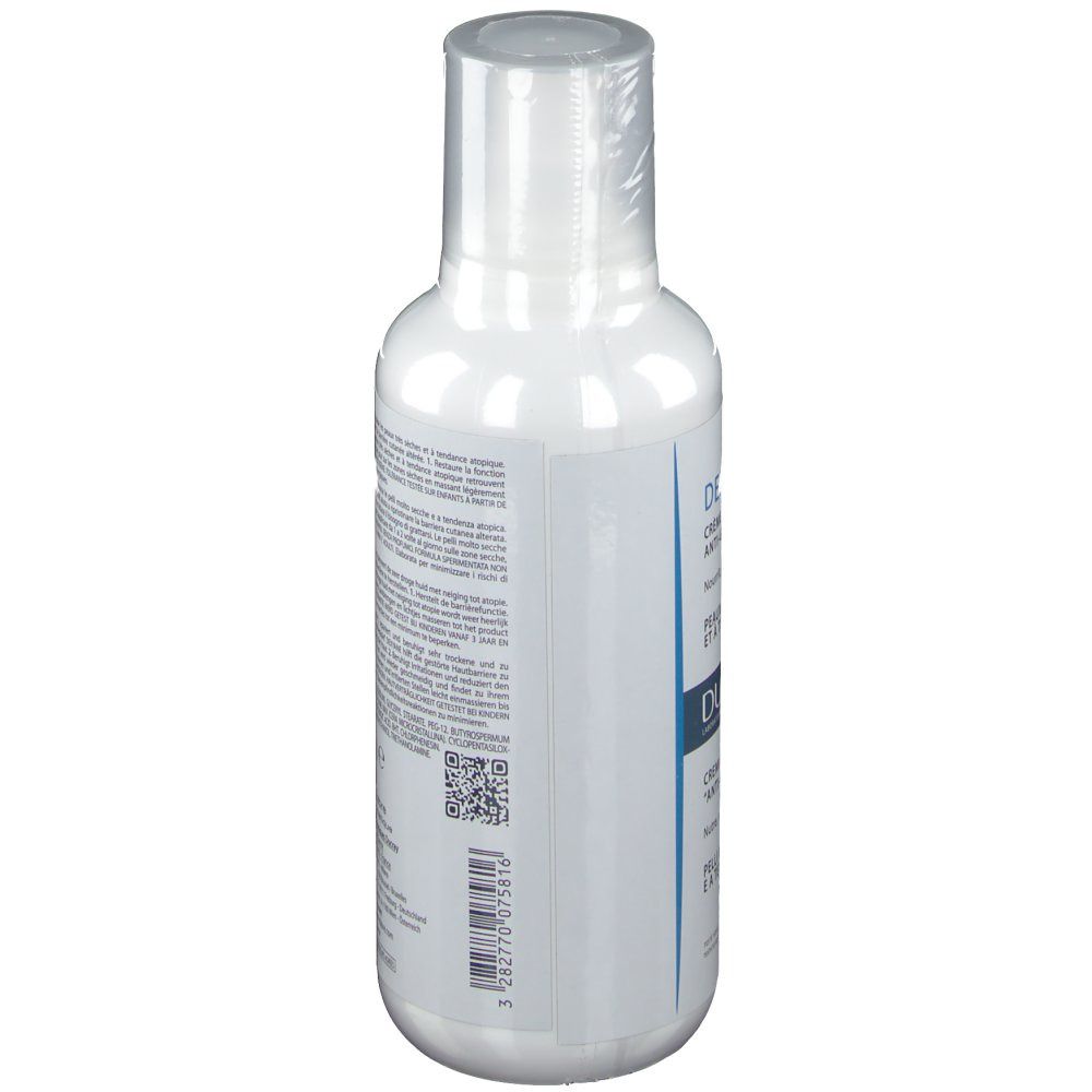 Flacone bianco con testo. Vista laterale. Crema DUCRAY DEXYANE. Testo multilingue.