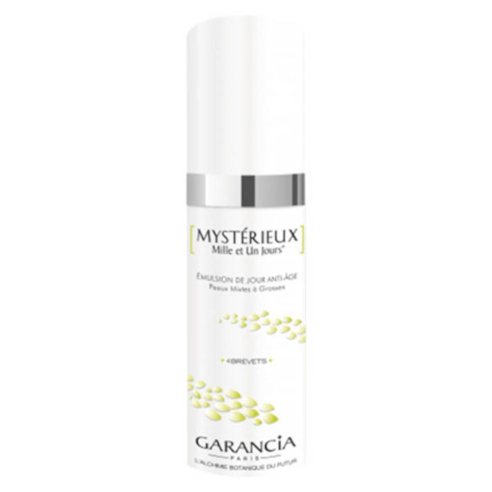 Flacone bianco con tappo argentato. Scritta: Mystérieux Mille et Un Jours, Garancia. Design verde con gocce.