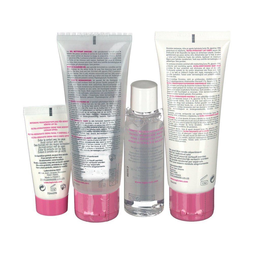 Vista posteriore di quattro prodotti cosmetici. Tubi bianchi con dettagli rosa. Testo e informazioni sul prodotto visibili.