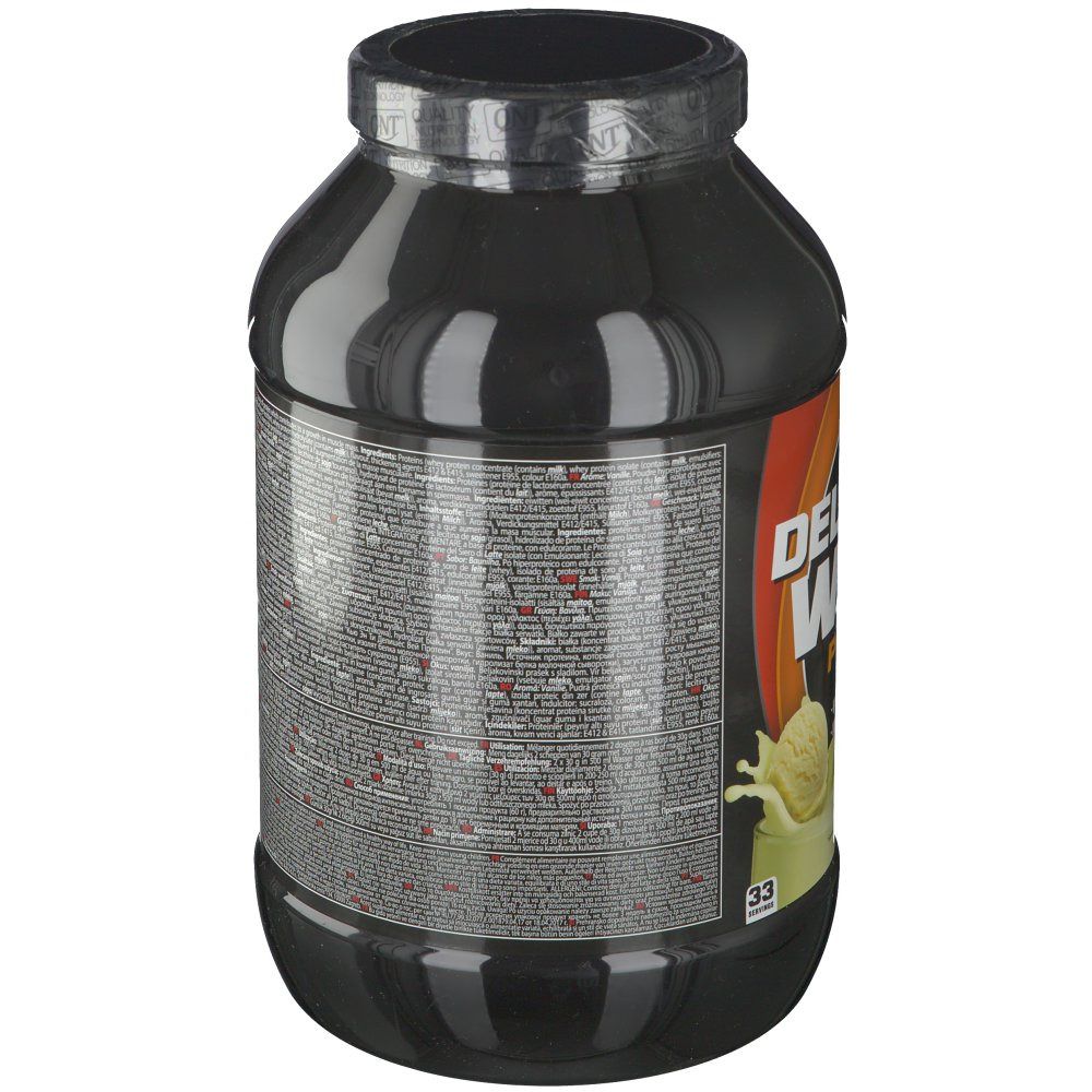 Retro del barattolo nero QNT Delicious Whey Protein. Testo multilingue. Coperchio nero. Striscia arancione.