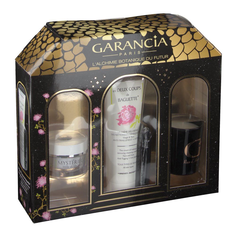 Confezione regalo con tre prodotti: crema, tubo e candela. Imballaggio nero e oro con design a finestre.