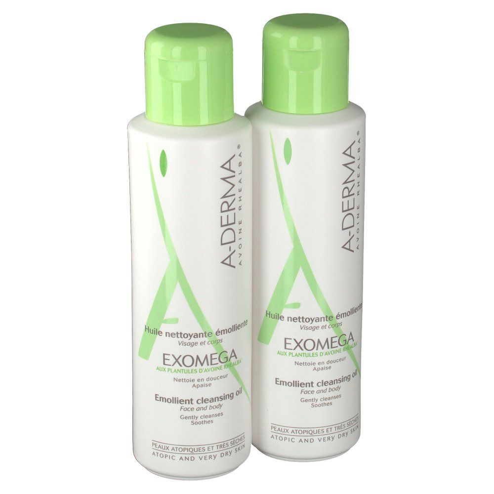Due flaconi A-Derma EXOMEGA Duo Aceite Limpiador Emoliente. Flaconi bianchi con tappi verdi. Testo: Emollient cleansing oil.