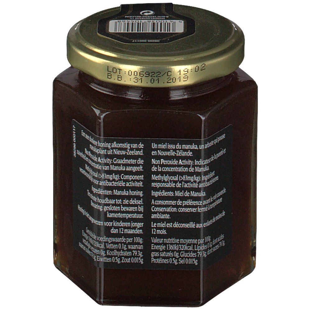 Vasetto di miele esagonale con testo su etichetta nera e coperchio dorato. Codice a barre sul coperchio.