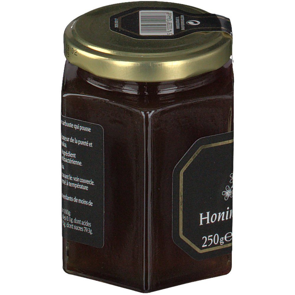 Vasetto di miele esagonale con etichetta nera e testo. Coperchio dorato. Scritta 'Honing' e '250ge'.