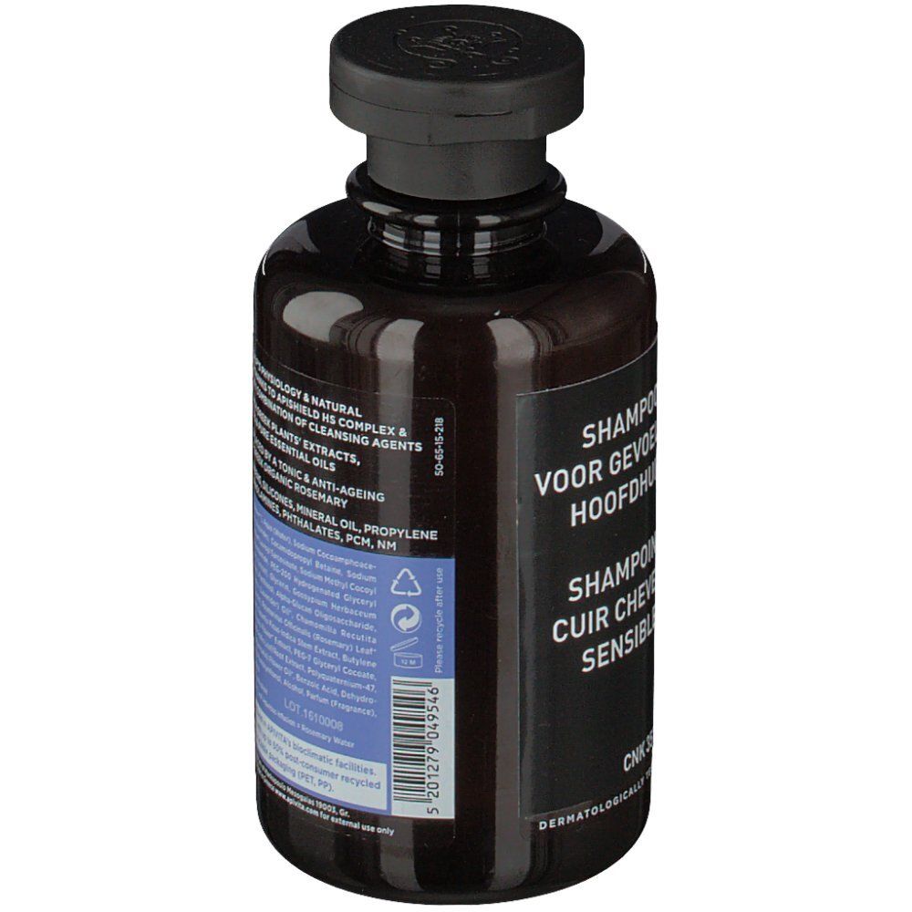 Retro del flacone marrone. Etichetta nera con testo multilingue. Testato dermatologicamente.