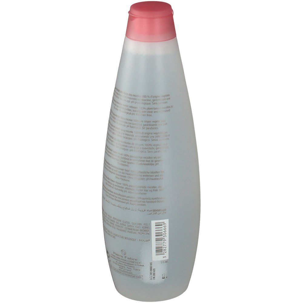 Flacone trasparente con tappo rosa. Testo sul flacone. Etichetta con informazioni e codice a barre.