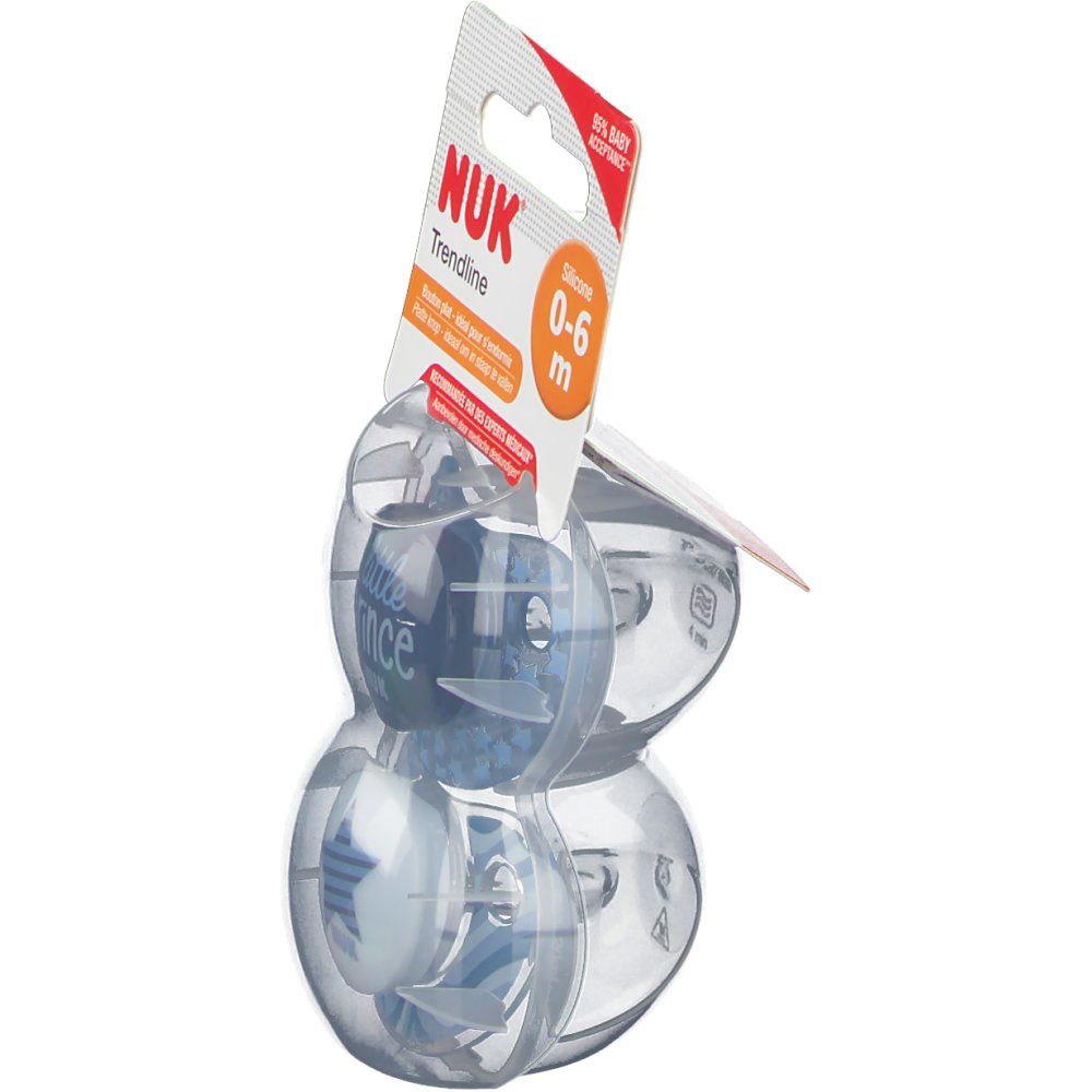 Due ciucci blu NUK Trendline in confezione. Visibile: 'NUK Trendline', '0-6 m'. Confezione in plastica.