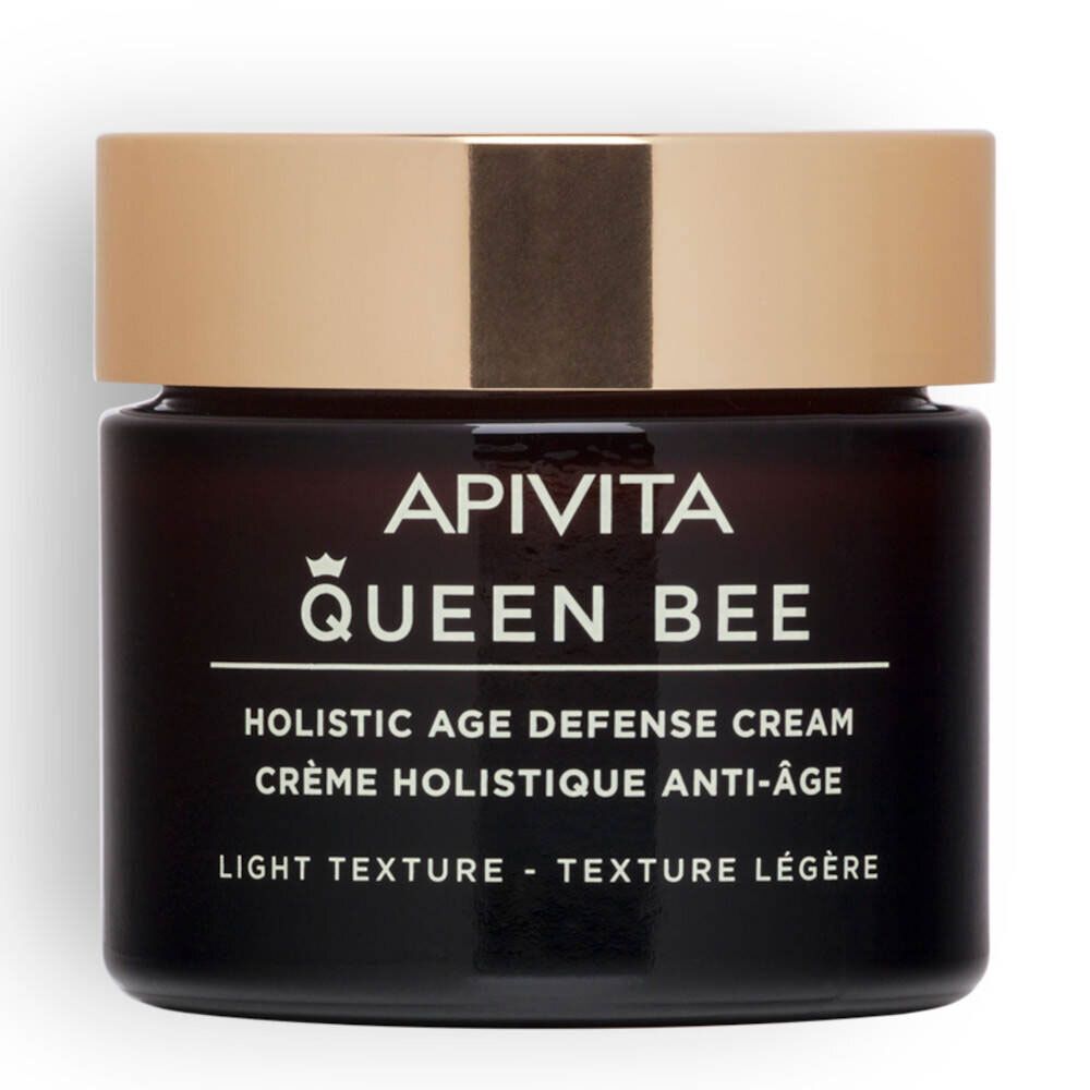 Vaso scuro con coperchio dorato. Scritta: APIVITA Queen Bee, Holistic Age Defense Cream, Texture Leggera.