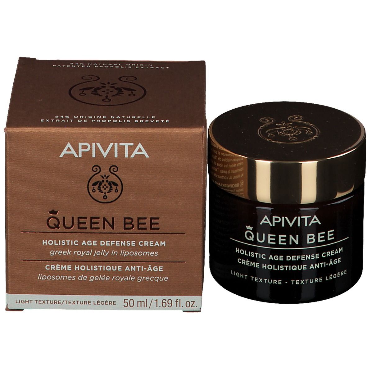Vaso e scatola di cartone. Scritta: APIVITA Queen Bee, Holistic Age Defense Cream, 50 ml. Testo in inglese e francese.