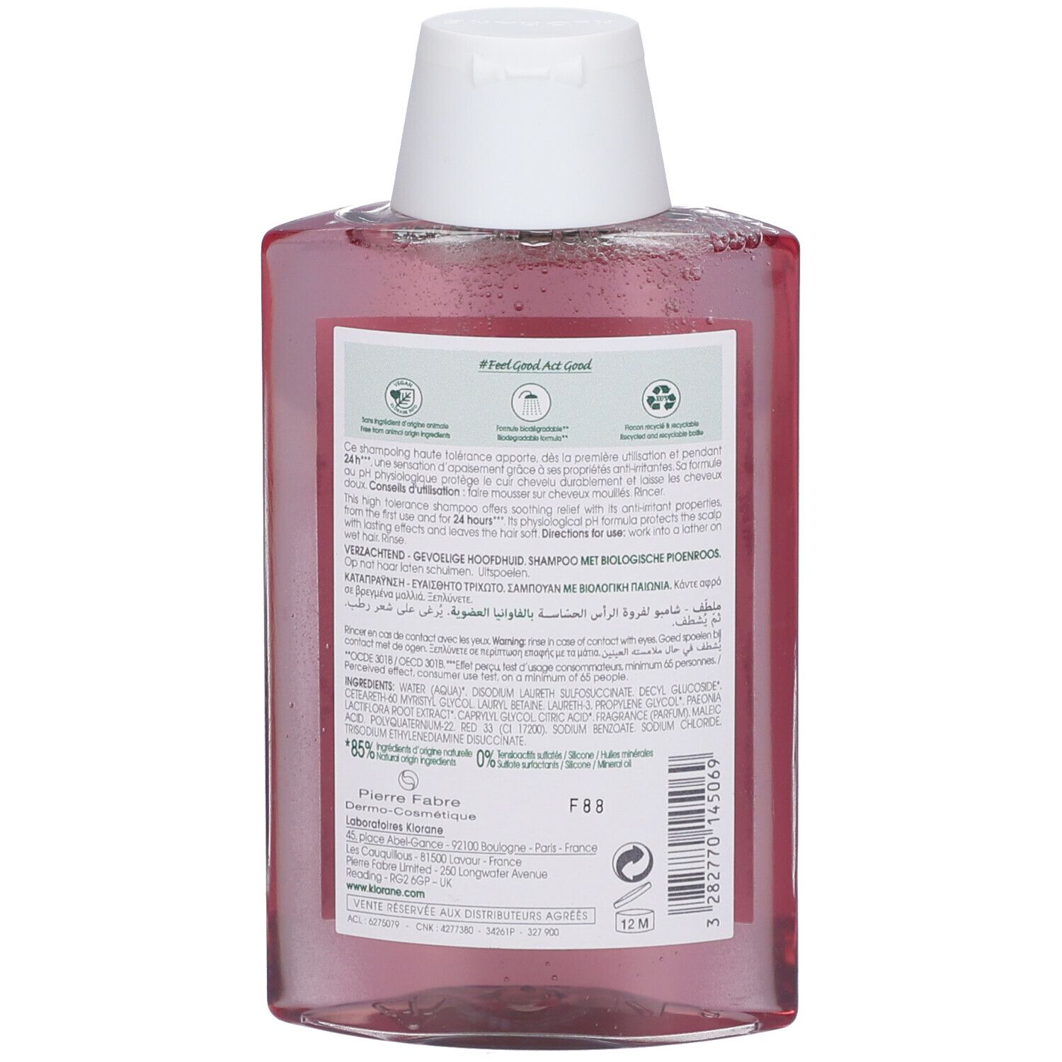 Retro di una bottiglia trasparente con liquido rosa, tappo bianco ed etichetta con informazioni sul prodotto.