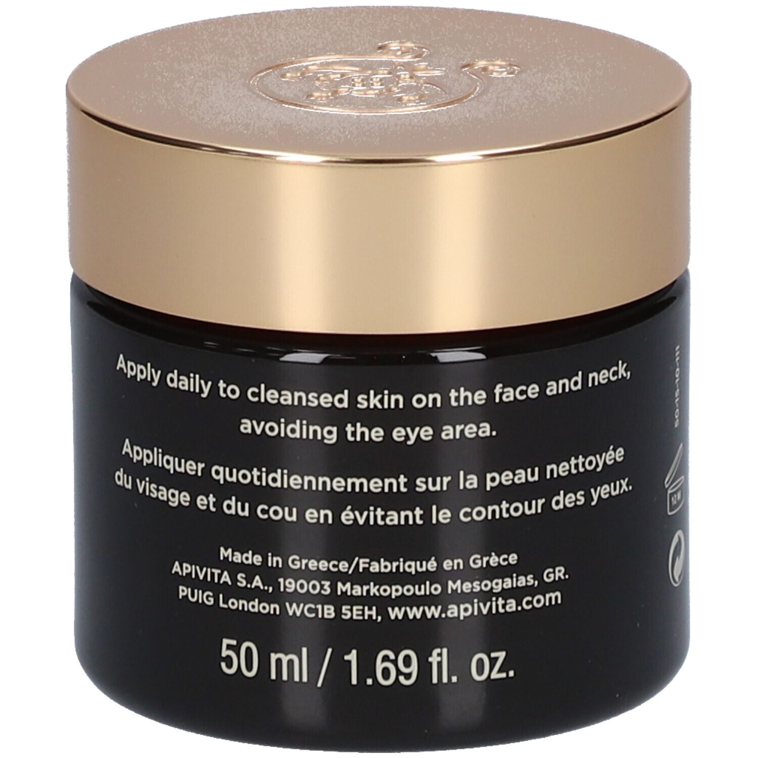 Vaso scuro con coperchio dorato. Scritta: APIVITA QUEEN BEE. Testo con istruzioni.