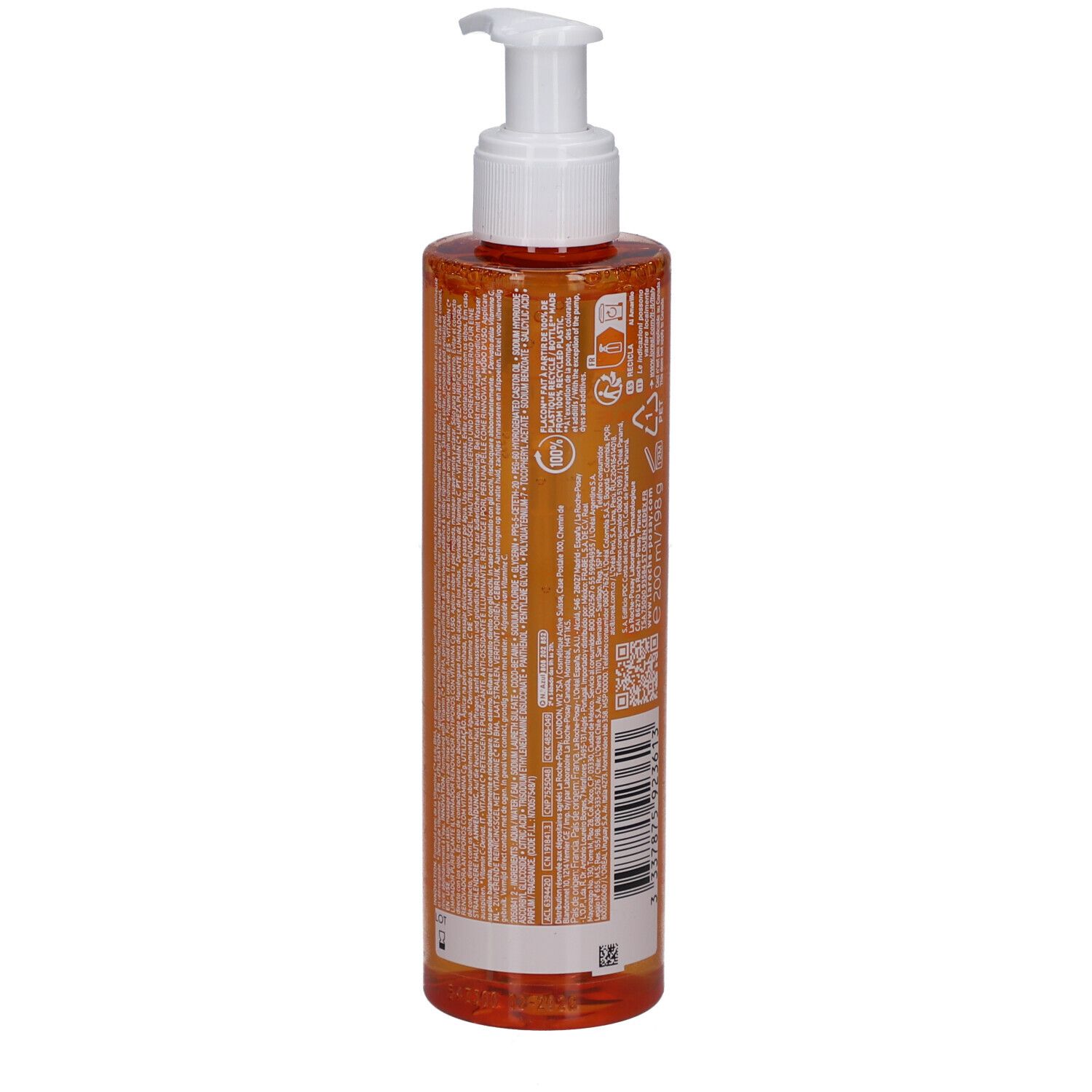 Liquido arancione in flacone trasparente con pompa e dispenser bianco.