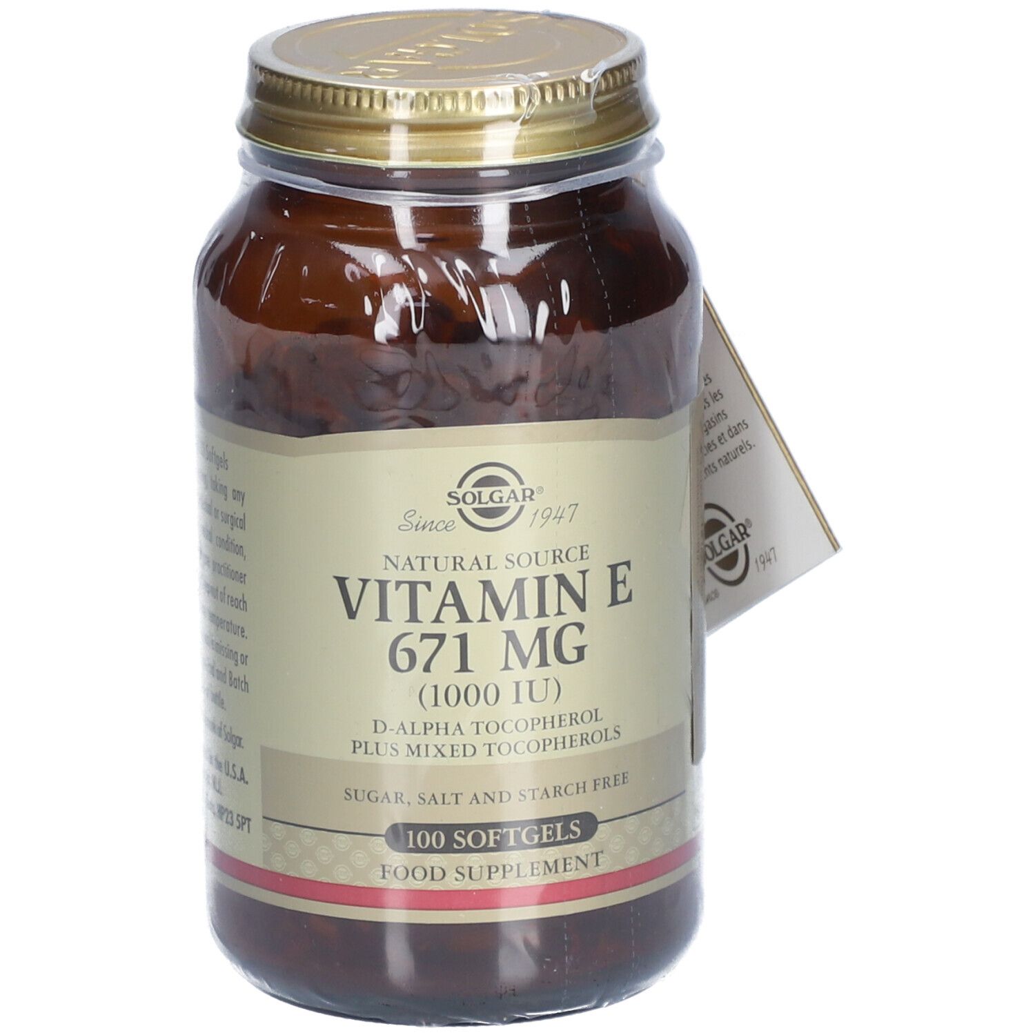 Flacone di vetro marrone con coperchio dorato. Etichetta: Vitamina E 671 mg, 100 softgels. Cartellino con logo.