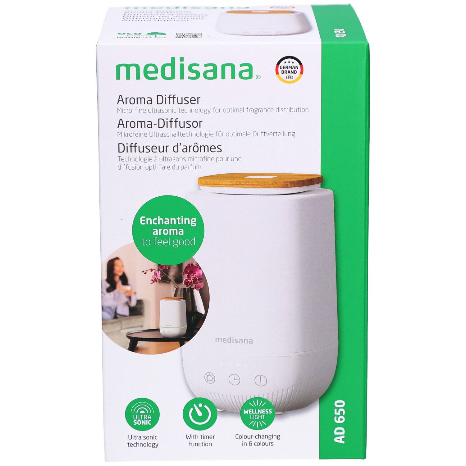 Diffusore di aromi in confezione. Bianco, coperchio in legno, confezione verde. Marchio: medisana. Nome: AD 650.