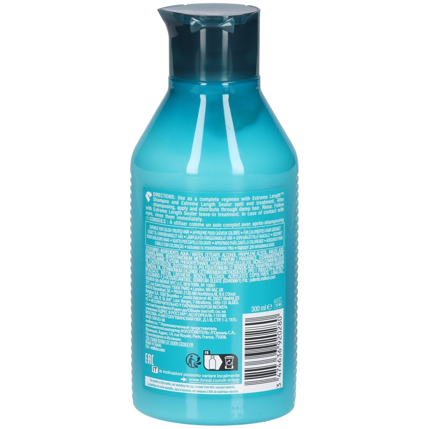 Retro di un flacone turchese con tappo blu scuro. Informazioni testuali e codice a barre. Contiene REDKEN Extreme Length Conditioner.