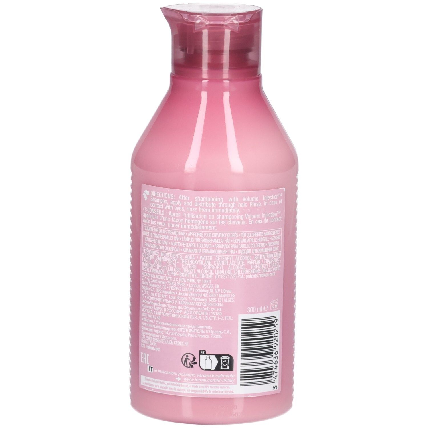 Vista posteriore di un flacone rosa con tappo rosso. Sul retro sono presenti testo, codice a barre e simboli.