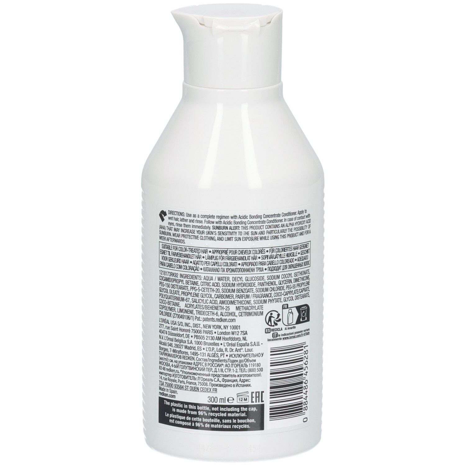 Flacone di shampoo bianco. Retro con testo e codice a barre. Marca: Redken. 300ml.