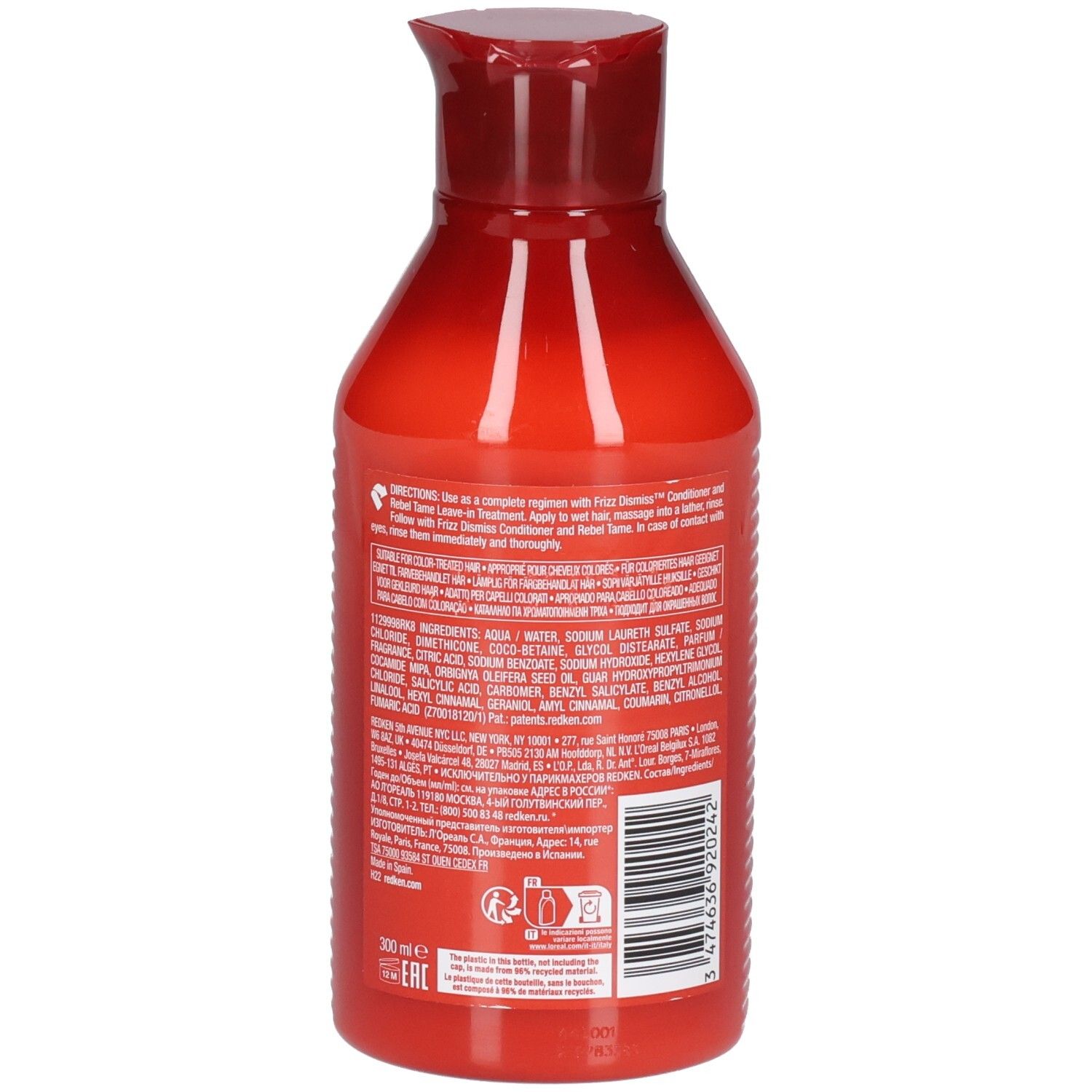 Retro di un flacone di shampoo rosso. Contiene testo sugli ingredienti e l'uso. Codice a barre e logo.