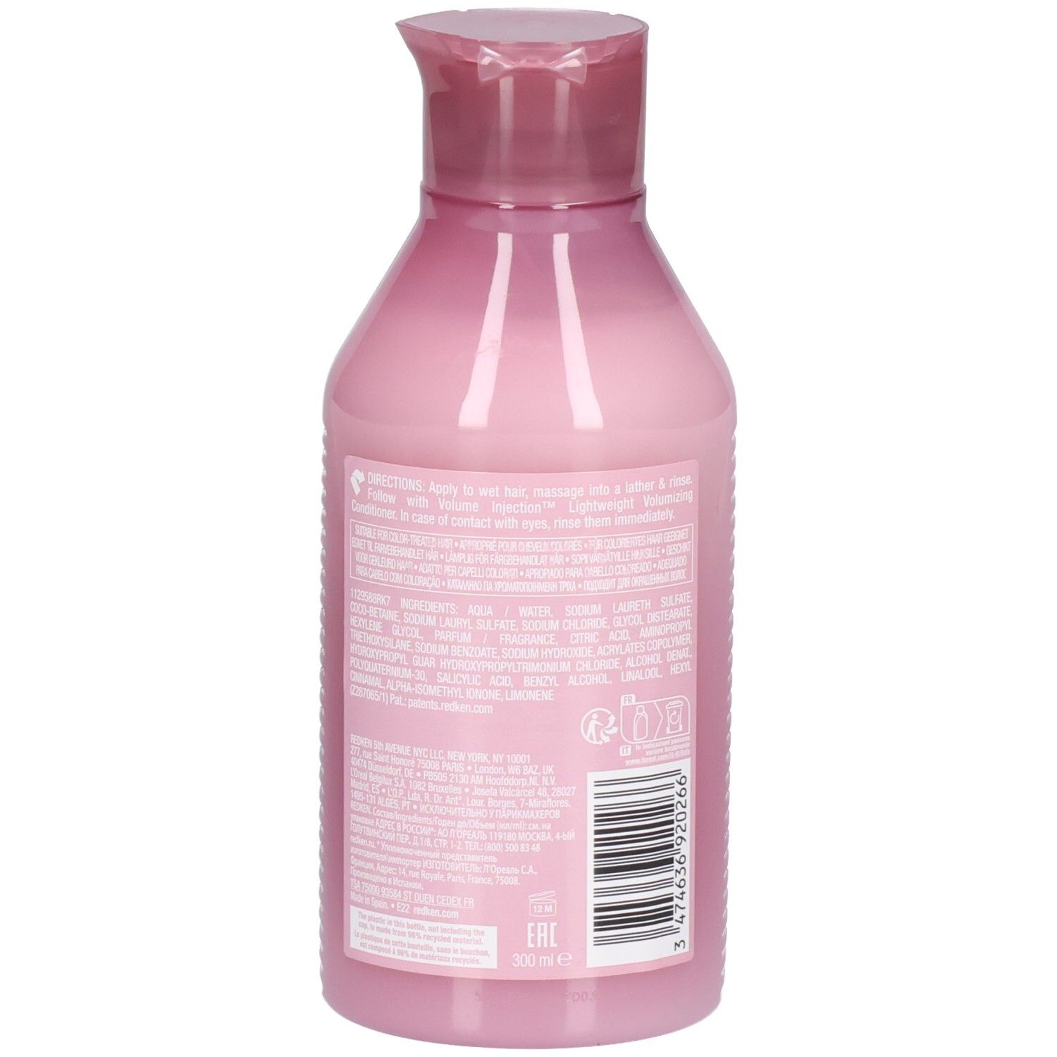 Retro di un flacone di shampoo rosa con testo. Codice a barre e informazioni del produttore visibili.