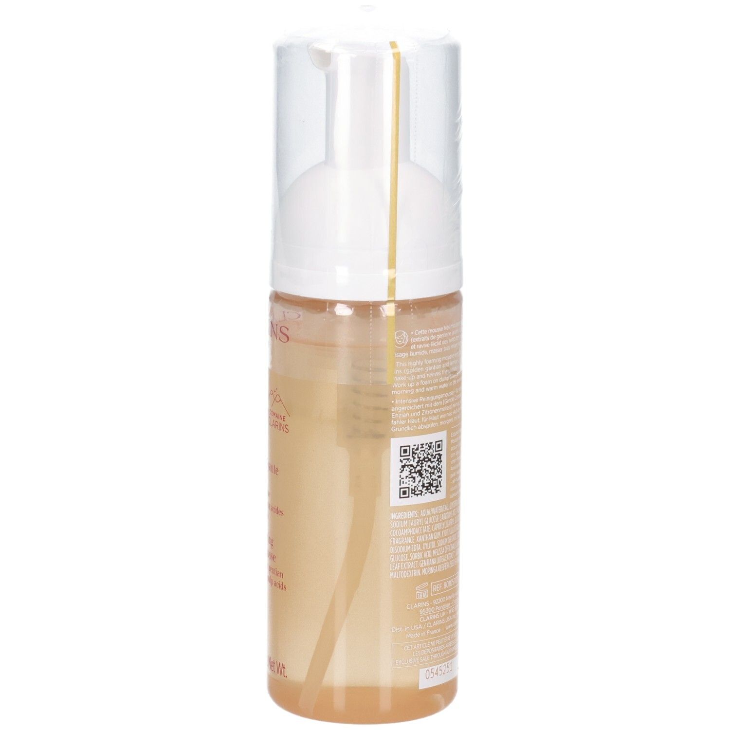 Lato di una bottiglia di mousse detergente Clarins con codice QR e testo. Erogatore trasparente con liquido giallo.