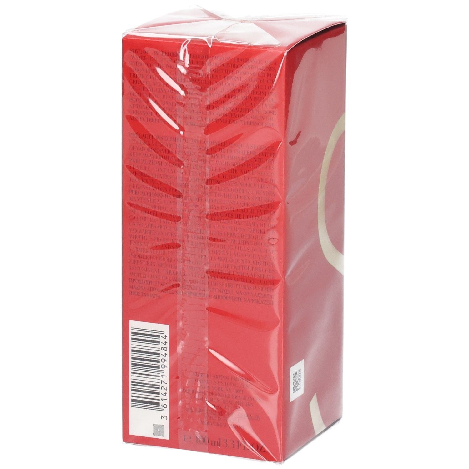 Scatola rossa con codice a barre e design a cerchio dorato, avvolta in pellicola trasparente.
