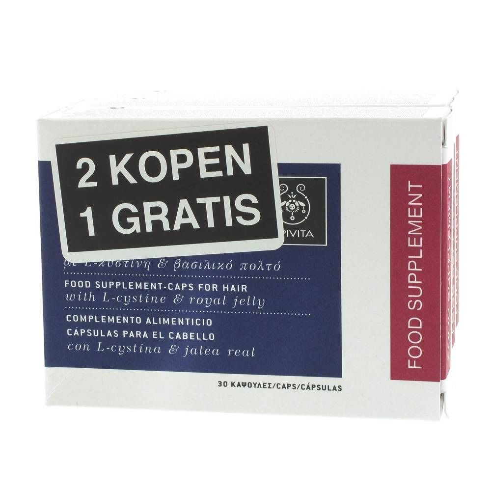 Scatola bianca con testo "2 KOPEN 1 GRATIS". Accenti blu e rossi. Testo: "FOOD SUPPLEMENT-CAPS FOR HAIR".