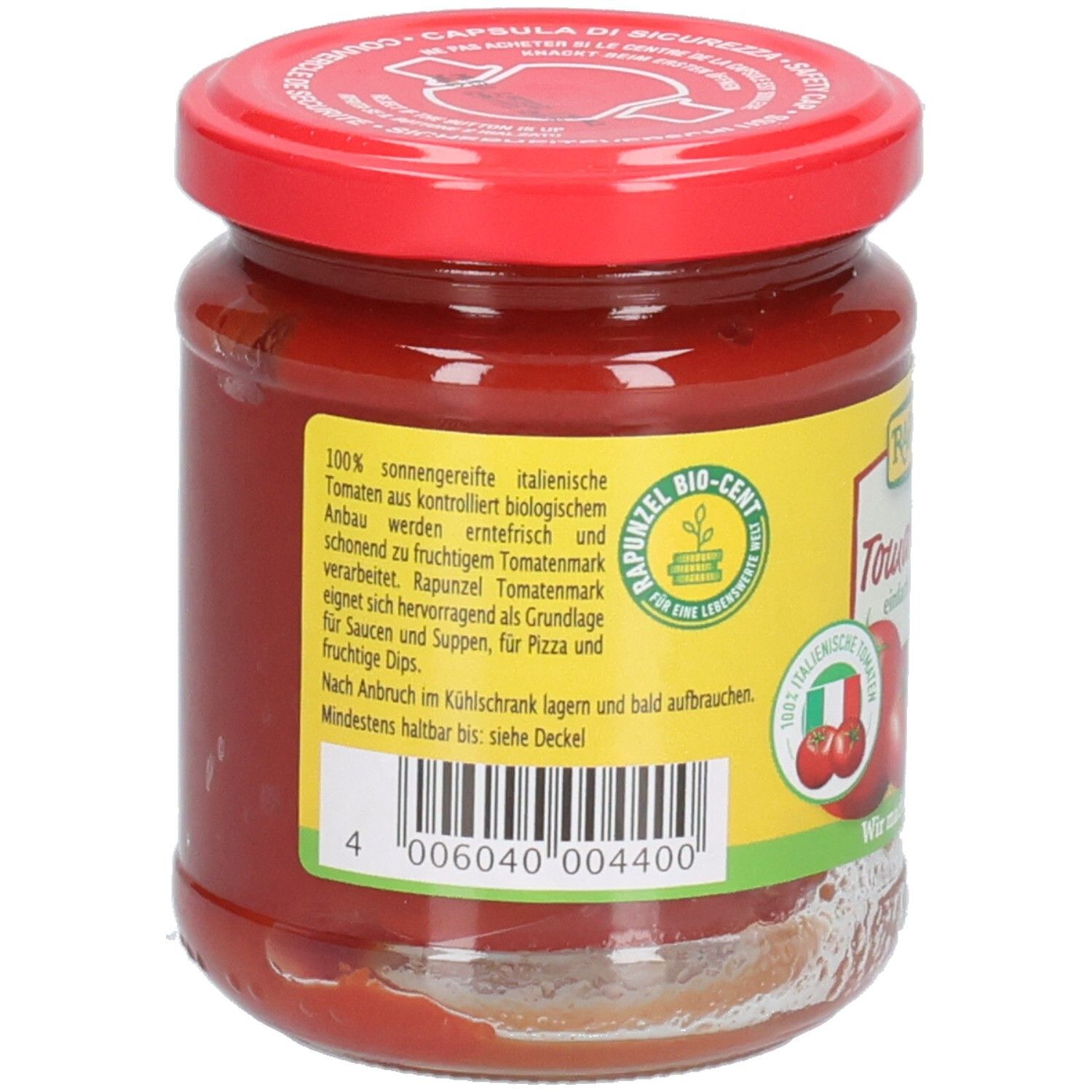Retro del vasetto di concentrato di pomodoro. Etichetta con testo, codice a barre, marchio bio e bandiera italiana.